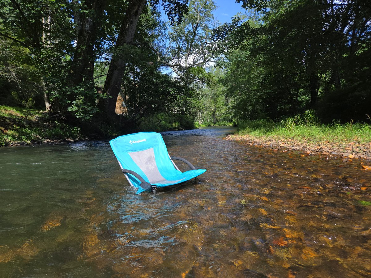 Camp chairs set in the Toccoa River at a North Georgia river cabin