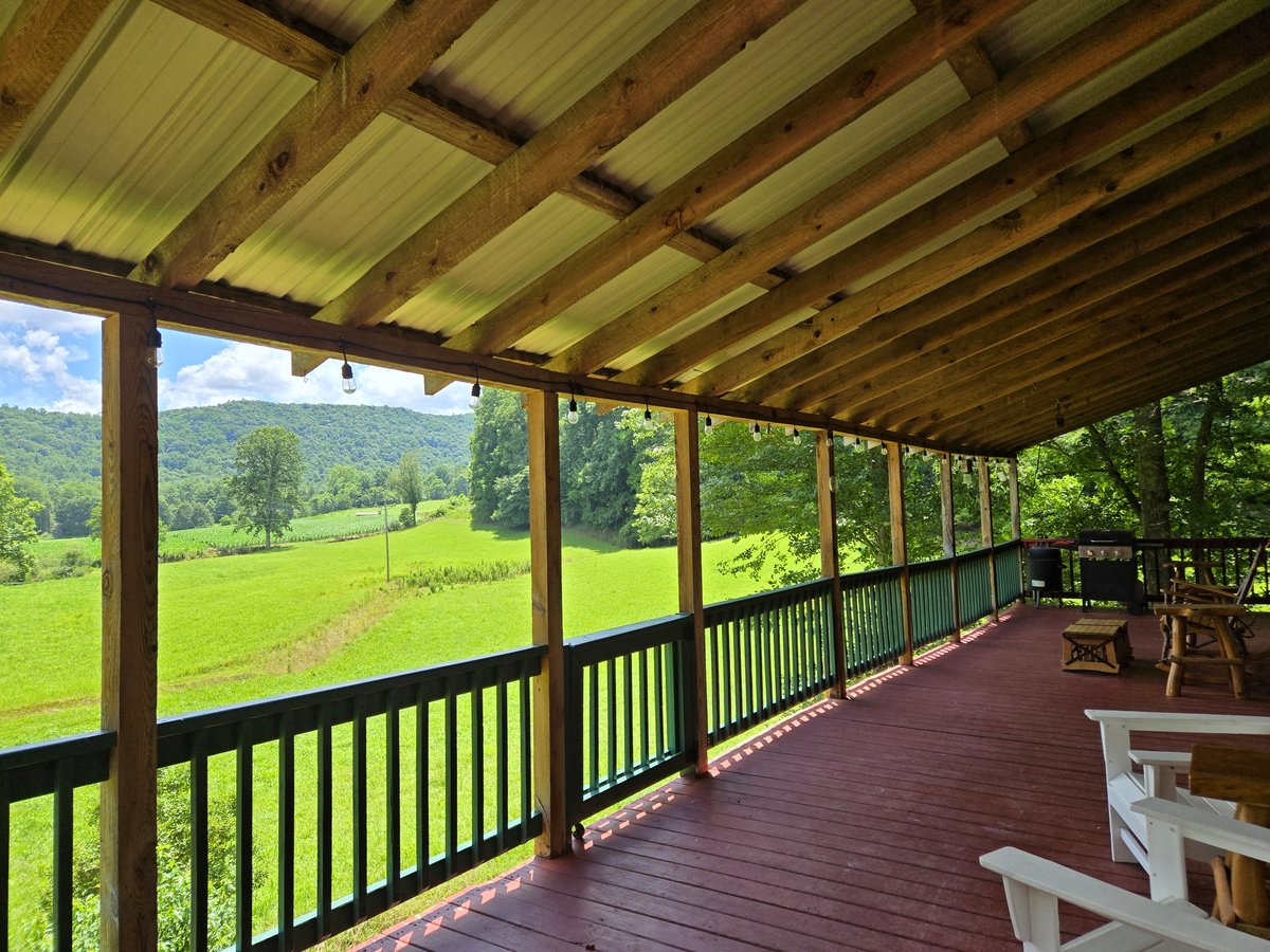 Morning view from the Headwaters porch in Suches GA — green pasture and North Georgia mountain
